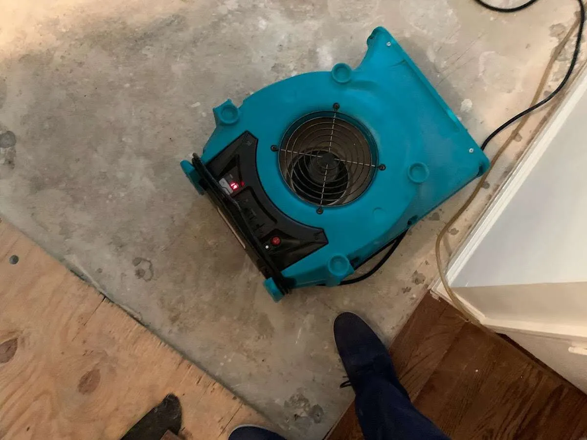 Air mover drying subfloor during Commercial Water Damage Restoration in Waupaca